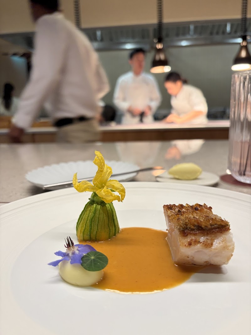 Chef Shusuke Kubota plating at open kitchen